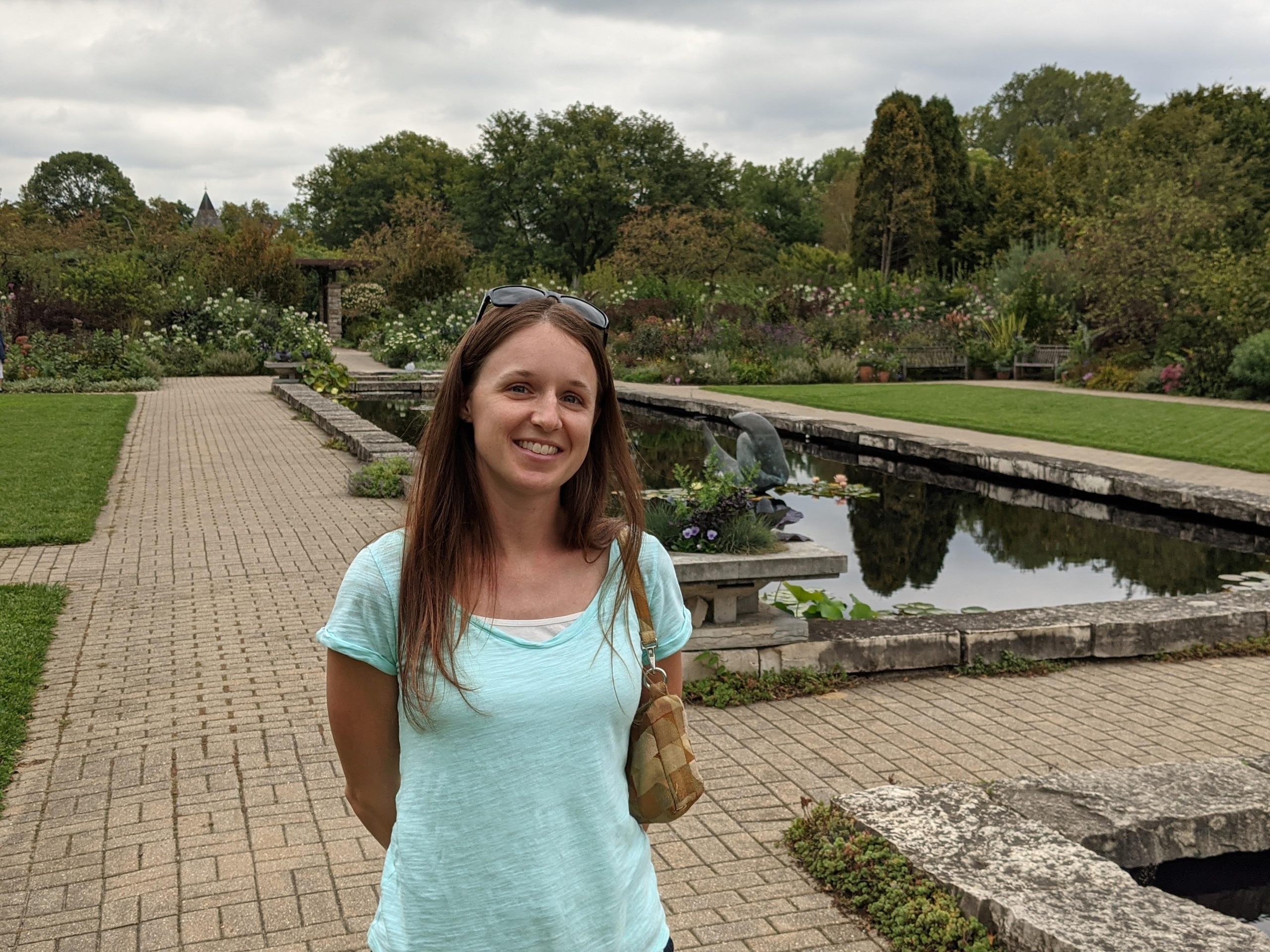 Woman standing on path in front of reflection pool