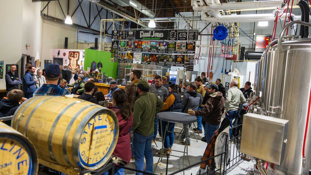 An engaged group gathers within a brewery. 